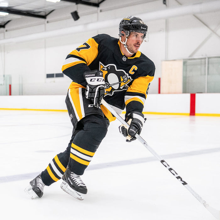 white ccm hockey stick with player